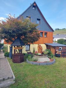 een huis met een tuin en een tuinhuisje bij Ferienwohnung-Barth in Schwarzenberg/Erzgebirge