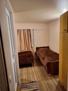 a small room with two beds and a window at Lux-2-or-1- persons Irodion Edoshvili Street #15 in Kutaisi