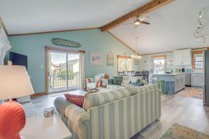 a living room with two couches and a kitchen at Coastal Home with Deck, Outdoor Shower Walk to Beach in Kill Devil Hills