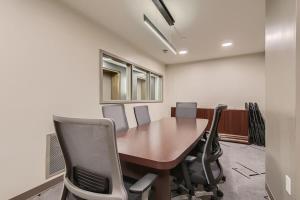 a conference room with a wooden table and chairs at Larimer Luxury Top Notch Amenities Walk to All in Denver