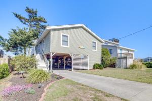 a house with a garage and a driveway at Coastal Home with Deck, Outdoor Shower Walk to Beach in Kill Devil Hills