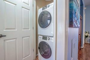 a washer and dryer in a room next to a door at Teal lake 1311 in North Myrtle Beach