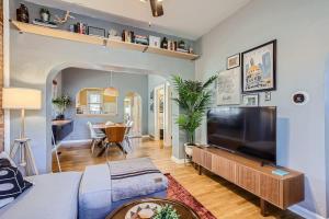 a living room with a large flat screen tv at RiNo Charmer 2bd Family Home Ev Charger in Denver