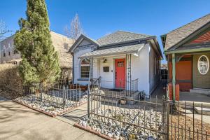 a white house with a red door and a fence at RiNo Charmer 2bd Family Home Ev Charger in Denver