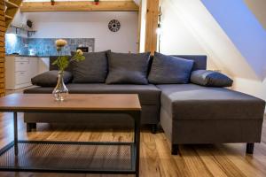 a living room with a couch and a table at Apartmány ve Dvoře in Herálec