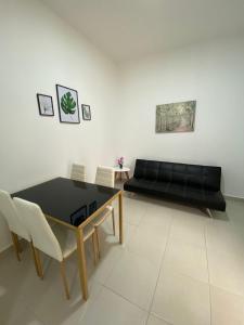 a living room with a black couch and a table at Sachar Lodging Apartahotel in Bucaramanga