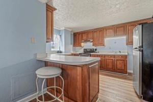 a kitchen with wooden cabinets and a white counter top at Charming Condo one block from the beach - WR 301 in Myrtle Beach