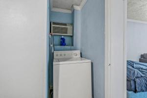 a small kitchen with a stove and a microwave at Charming Condo one block from the beach - WR 301 in Myrtle Beach