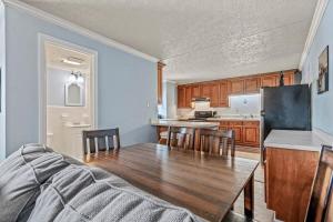 a kitchen with a wooden table and a dining room at Charming Condo one block from the beach - WR 301 in Myrtle Beach