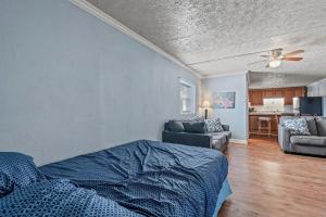 a bedroom with a bed and a living room at Charming Condo one block from the beach - WR 301 in Myrtle Beach