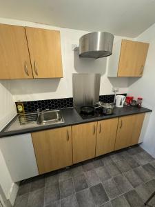 a kitchen with a sink and a counter top at Crete Room in Oldham