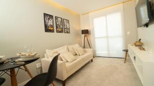 a living room with a white couch and a table at Flat Jardim Paulista II - SP - Próximo da AV Paulista e ao lado do Shopping Pamplona in Sao Paulo +32 photos