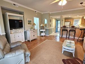a living room with a couch and a table at Teal Lake 1413 in North Myrtle Beach