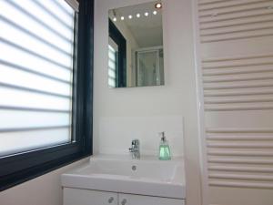 a bathroom with a sink and a mirror at Houseboat Floating Houses Blue Active, Ribnitz-Damgarten in Ribnitz-Damgarten