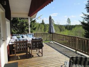 a wooden deck with a table and an umbrella at Haus Rangen in Brograngen