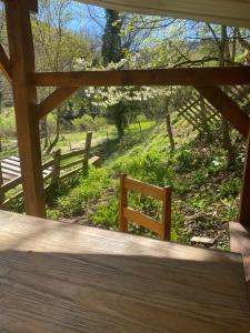 a wooden porch with a view of a fence at Camping Les Escargots Bleus in Prades