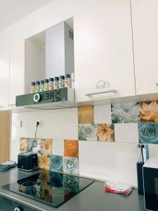 a kitchen with white cabinets and a counter with a toaster at Hostel Central Skopje in Skopje