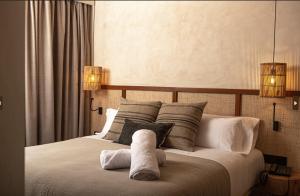 a bedroom with a bed with two towels on it at Albades Hotel & Spa - Adults Only in Benicàssim