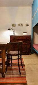 a desk with a lamp and a chair in a room at Kőpajta Vendégház in Barnag