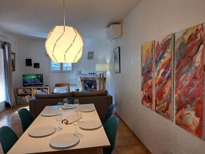a dining room with a table and a living room at Villa Provençale à Mougins in Mougins