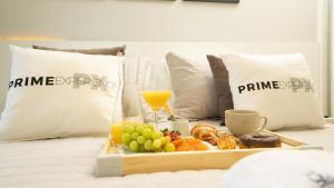 a tray of food with a glass of orange juice and fruit at Flat Jardim Paulista - SP - Próximo da AV Paulista e ao lado do Shopping Pamplona in Sao Paulo