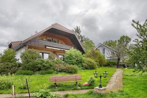 a house with a park bench in front of it at Zum Alt Engelwirt in Horben