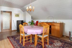 a dining room with a pink table and chairs at Zum Alt Engelwirt in Horben