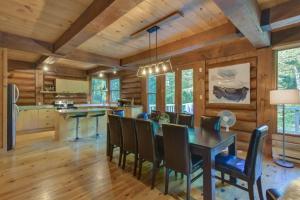 a dining room with a table and chairs at Spacious log cottage Resort access in Lac-Superieur