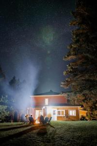a house at night with a starry sky at SPA private pond and beach volleyball in Lac-Superieur