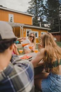 a group of people sitting around a table drinking juice at SPA private pond and beach volleyball in Lac-Superieur