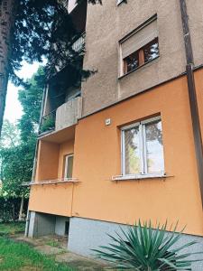 an orange building with two windows on the side of it at Hostel Central Skopje in Skopje