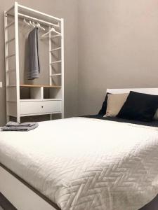 a bedroom with a white bed and a closet at 4 bedrooms apartement with city view balcony and wifi at Catania 1 km away from the beach in Catania