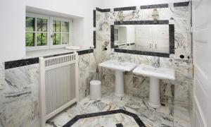a bathroom with two sinks and a mirror at Villa Pepita in Miedzygorze +134 photos