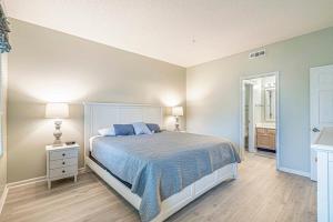 a bedroom with a bed with a blue comforter at Teal Lake Villas 1523 Golf Villa in North Myrtle Beach