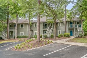 a large house with trees in front of it at Teal Lake Villas 1523 Golf Villa in North Myrtle Beach