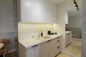 a kitchen with a sink and a counter at Nowolipie 31 - 2 sypialnie - Better Rental in Warsaw