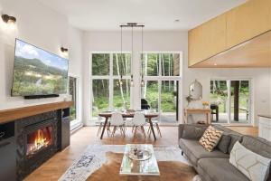 a living room with a couch and a fireplace at Chalet La Colline in Labelle