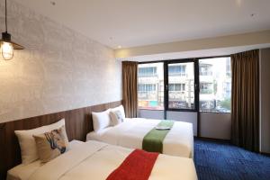 Postel nebo postele na pokoji v ubytování Ark Hotel - Changan Fuxing方舟商業股份有限公司
