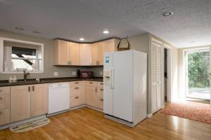 a kitchen with a white refrigerator and a window at #StayinMyDistrict St Johns Forest Park Retreat in Portland