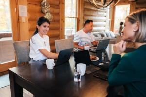 a group of people sitting at a table with laptops at Corpo Big Group or Family 20 people 2 properties in Lac-Superieur