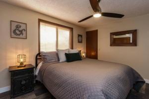 a bedroom with a bed and a ceiling fan at #StayInMyDistrict Eclectic Boise Townhouse near St Als in Boise