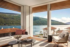 a living room with a view of the water at One&Only Portonovi in Herceg-Novi