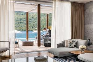 a living room with a view of the water at One&Only Portonovi in Herceg-Novi