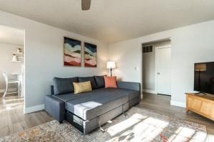 a living room with a couch and a flat screen tv at #StayinMyDistrict Downtown Meridian Cozy Home in Meridian