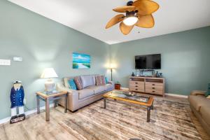 un soggiorno con divano e TV a schermo piatto di Romar Lakes 302-B a Orange Beach