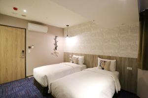 Postel nebo postele na pokoji v ubytování Ark Hotel - Changan Fuxing方舟商業股份有限公司
