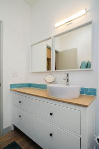 a bathroom with a sink and a mirror at #StayinMyDistrict Modern Mid-Century Retreat in Beaverton