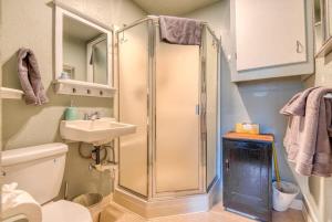 a bathroom with a shower and a toilet and a sink at #StayinMyDistrict Heritage House Private Suite in Coos Bay