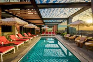a pool with chairs and umbrellas on a building at Virgin Hotels New Orleans in New Orleans