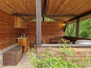 a porch of a wooden house with a bench at Vila Anna in Ribarica +22 photos